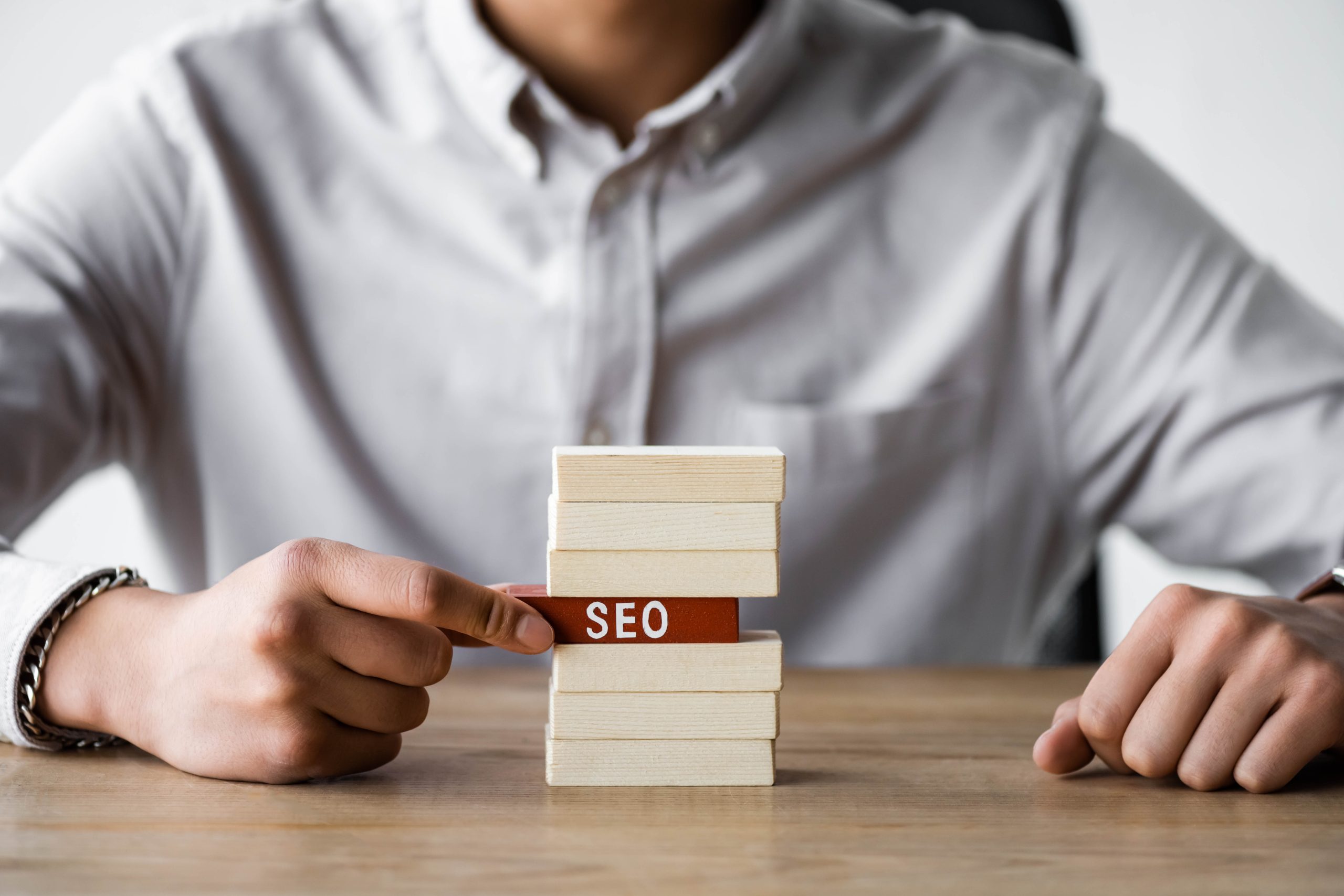 cropped view of seo manager holding wooden rectang 2022 12 16 15 37 24 utc scaled - Amplify Your Online Presence: Mastering Individual SEO and Cultivating Your Personal Brand for Job Search Success